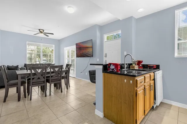 a living room with furniture a window and a flat screen tv