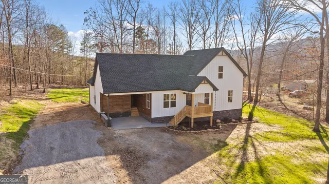 a view of a house with pool and a yard