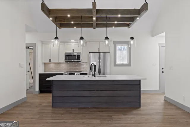 a kitchen with stainless steel appliances wooden cabinets a stove and a refrigerator