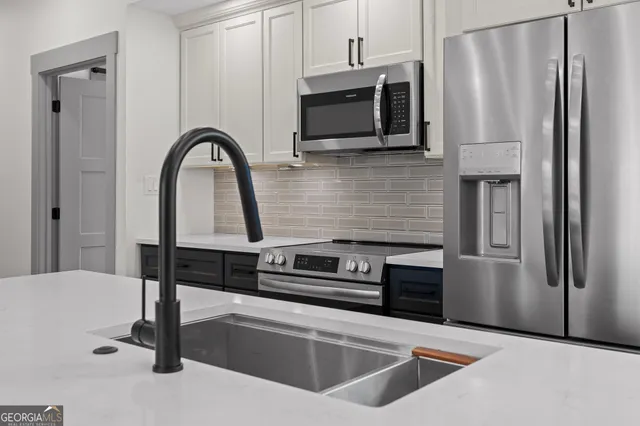a stove top oven sitting inside of a kitchen