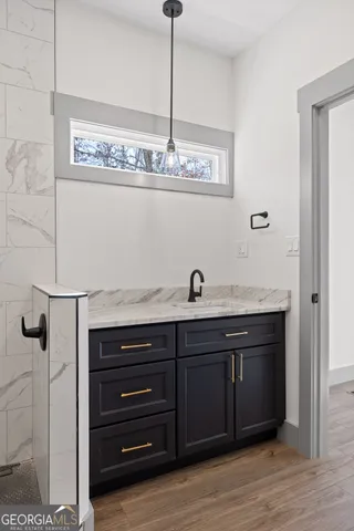 a view of a hallway with wooden floor and entryway