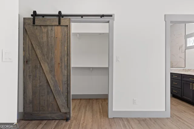 a view of a hallway with wooden floor and staircase