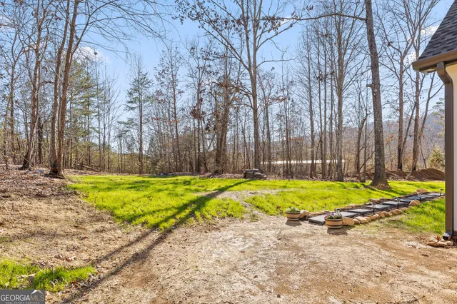 a front view of a house with plants