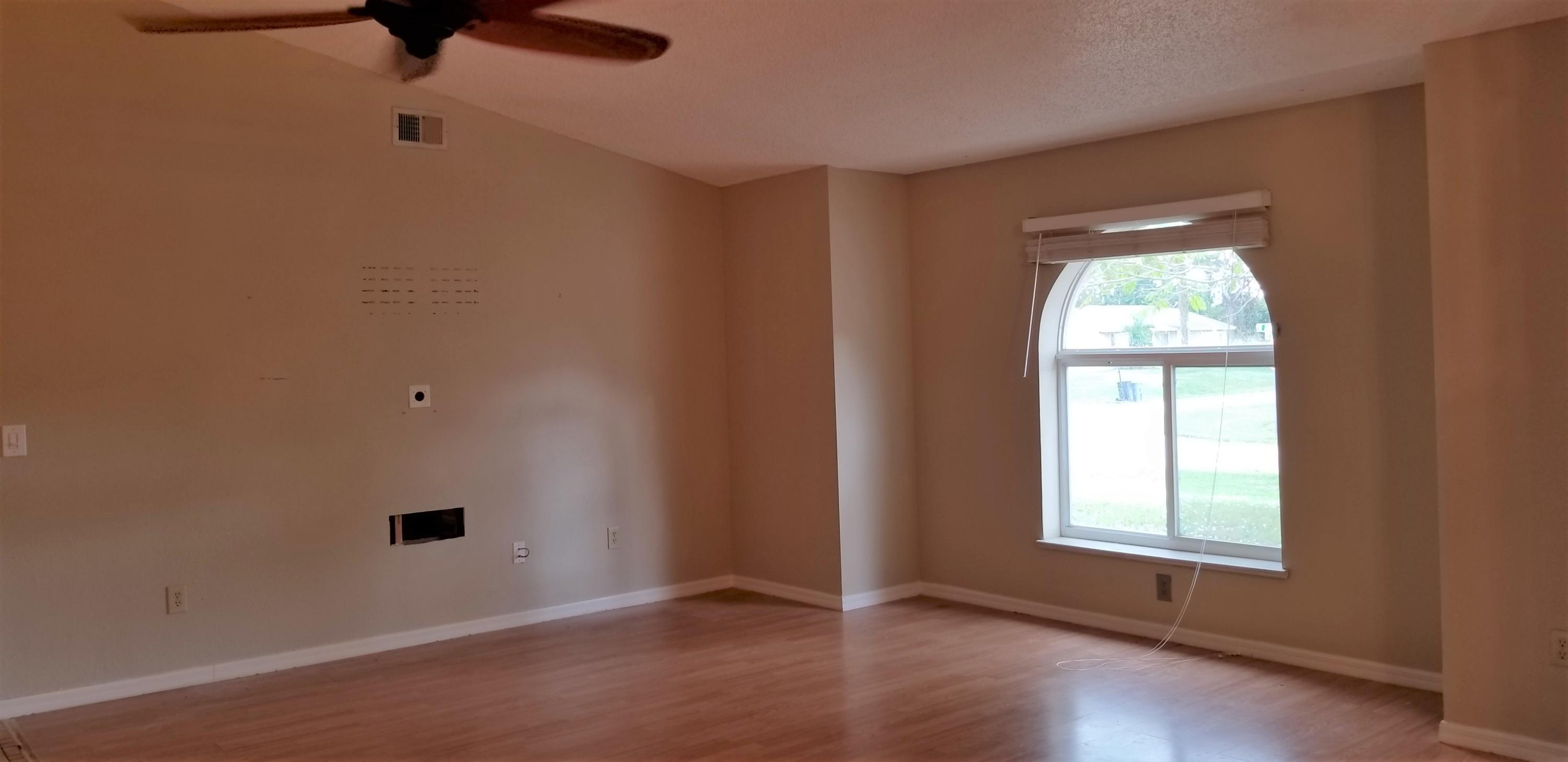 801 Southwest Andrew Road Port St. Lucie, FL 34953 - Photo 3 of 16 an empty room with a window
