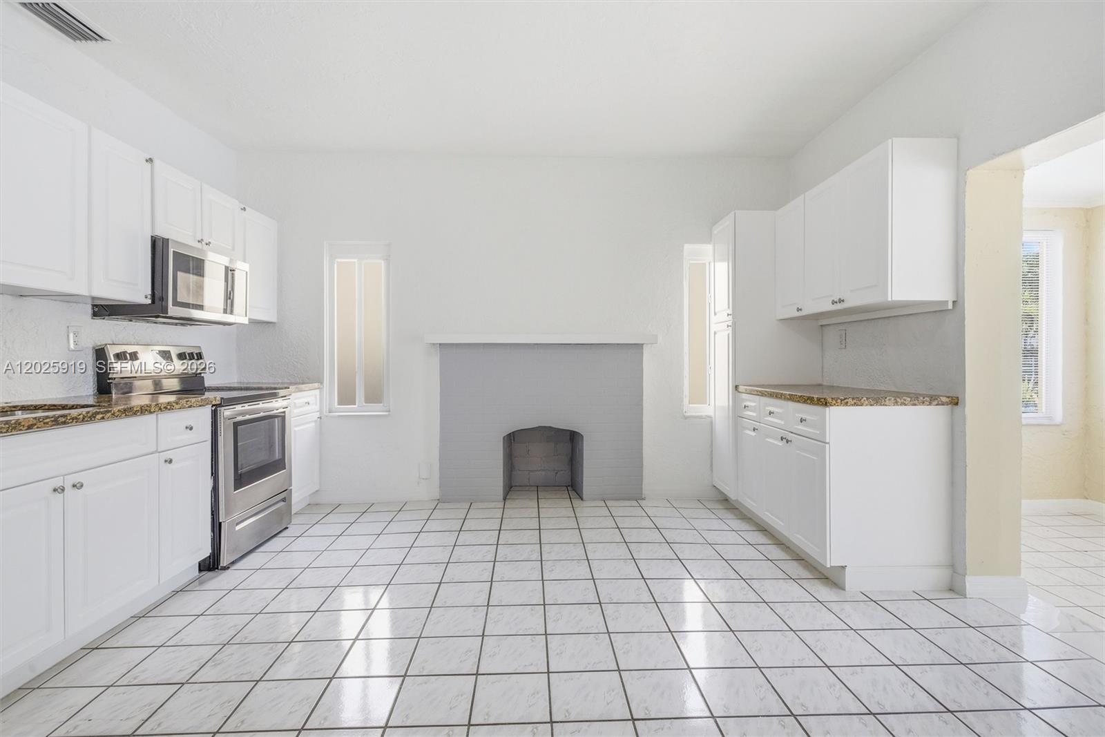 1743 Southwest 17th Street, Unit 1 Miami, FL 33145 - Photo 10 of 32 a kitchen with cabinets and white appliances