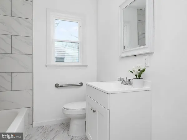a bathroom with a sink a toilet and mirror