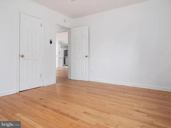 a view of an empty room and wooden floor