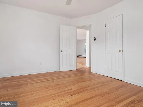 a view of an empty room and wooden floor
