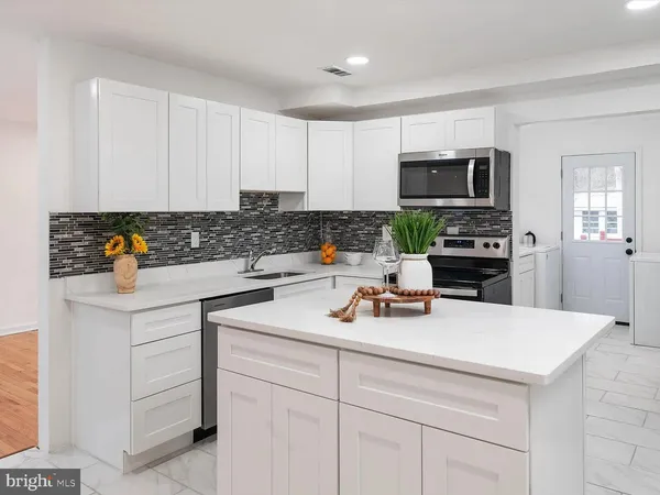 a kitchen with a sink a stove and cabinets