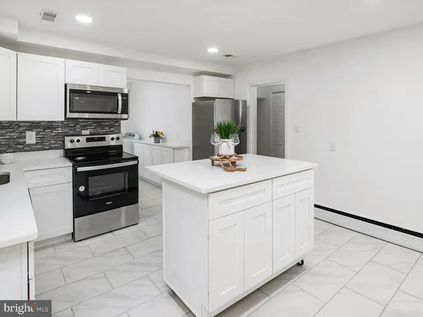 a kitchen with a sink cabinets and stainless steel appliances