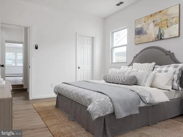 a bedroom with a bed and a couch