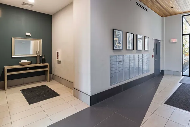 a view of kitchen with furniture and electronic appliances