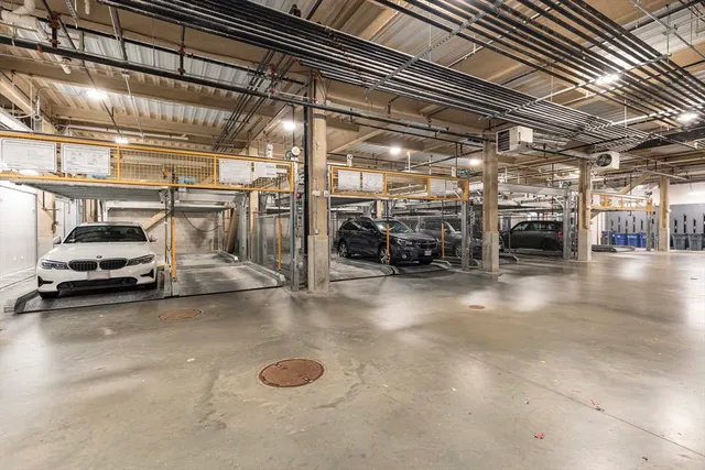 a view of parking garage with cars