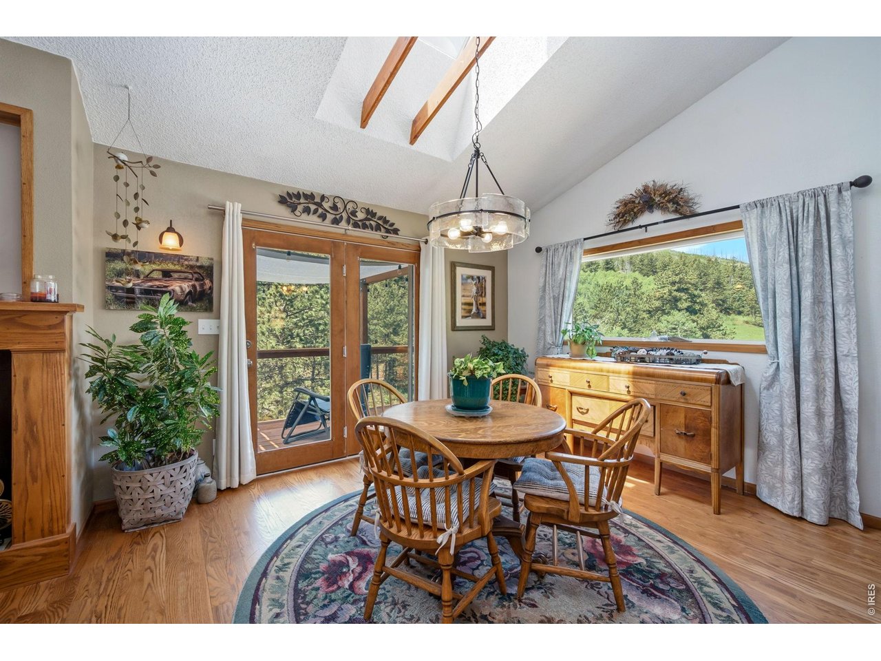1154 Spring Valley Road Bellvue, CO 80512 - Photo 10 of 31 Dining area with french doors out to deck and a window that looks over a large meadow.