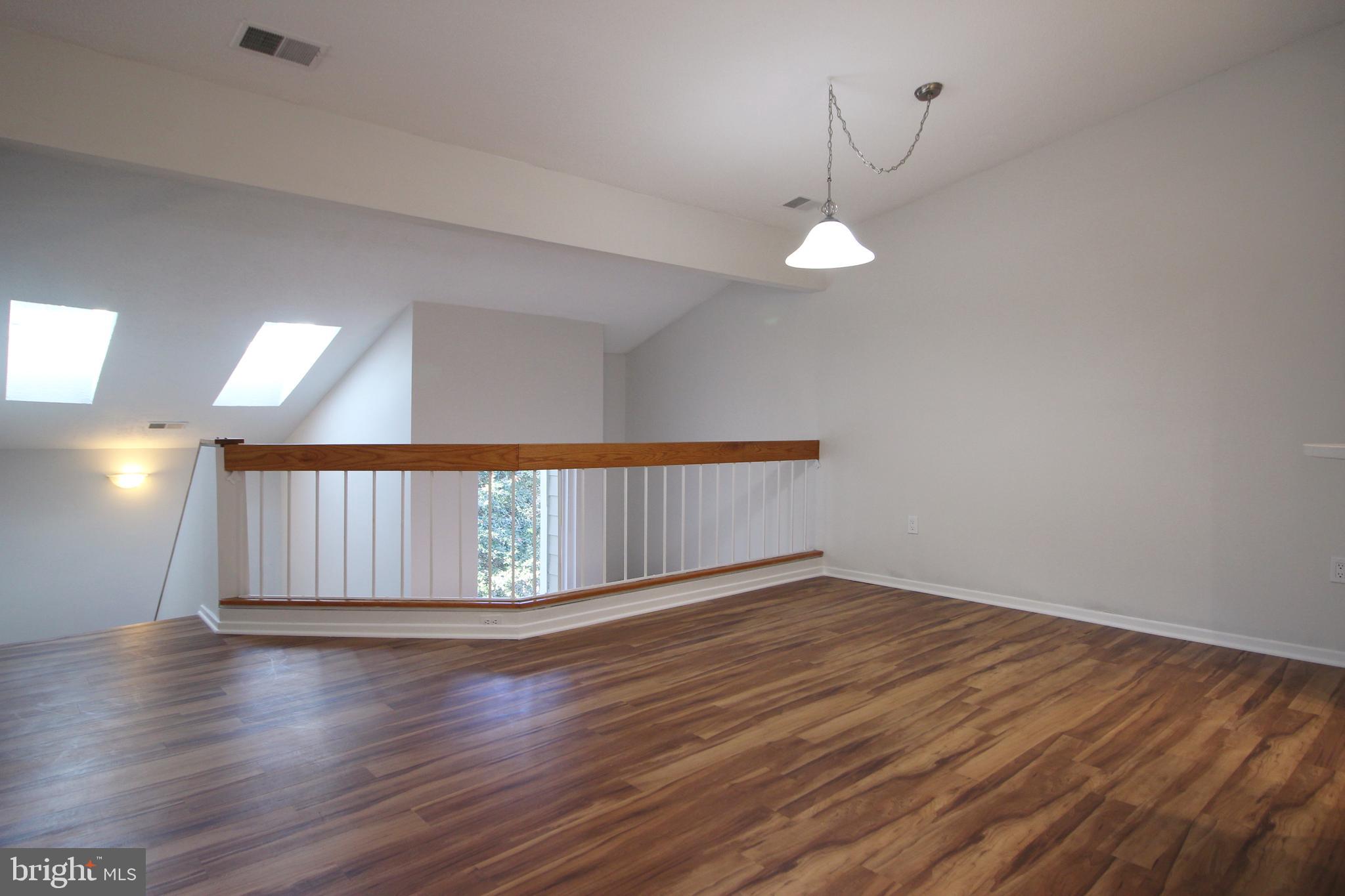 1956A Villaridge Drive, Unit 1956B Reston, VA 20191 - Photo 12 of 24 a view of an empty room with wooden floor and a window