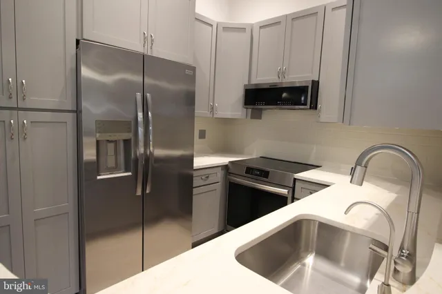 a kitchen with stainless steel appliances a refrigerator and a sink