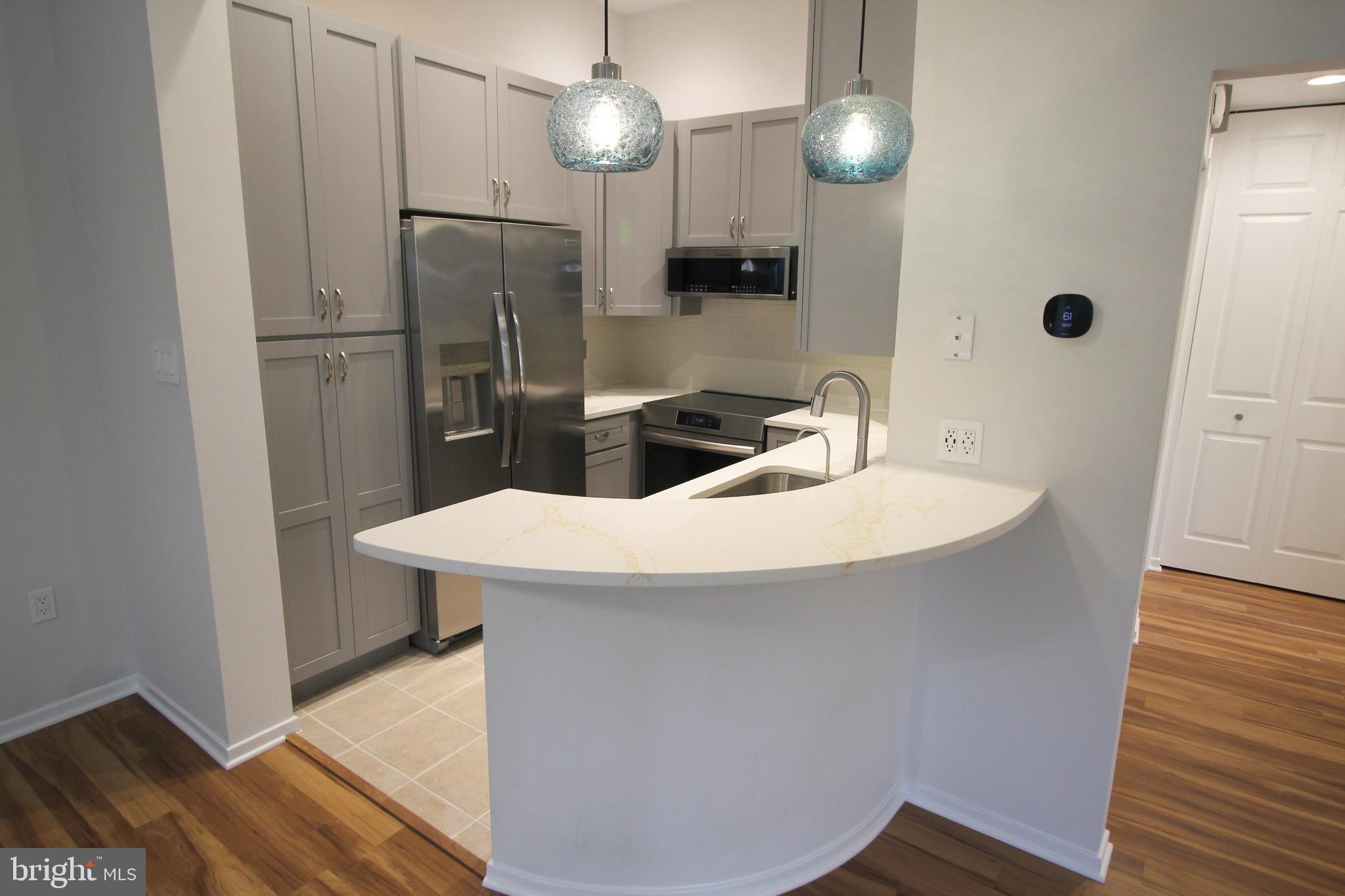 1956A Villaridge Drive, Unit 1956B Reston, VA 20191 - Photo 16 of 24 a kitchen with stainless steel appliances a refrigerator and a sink