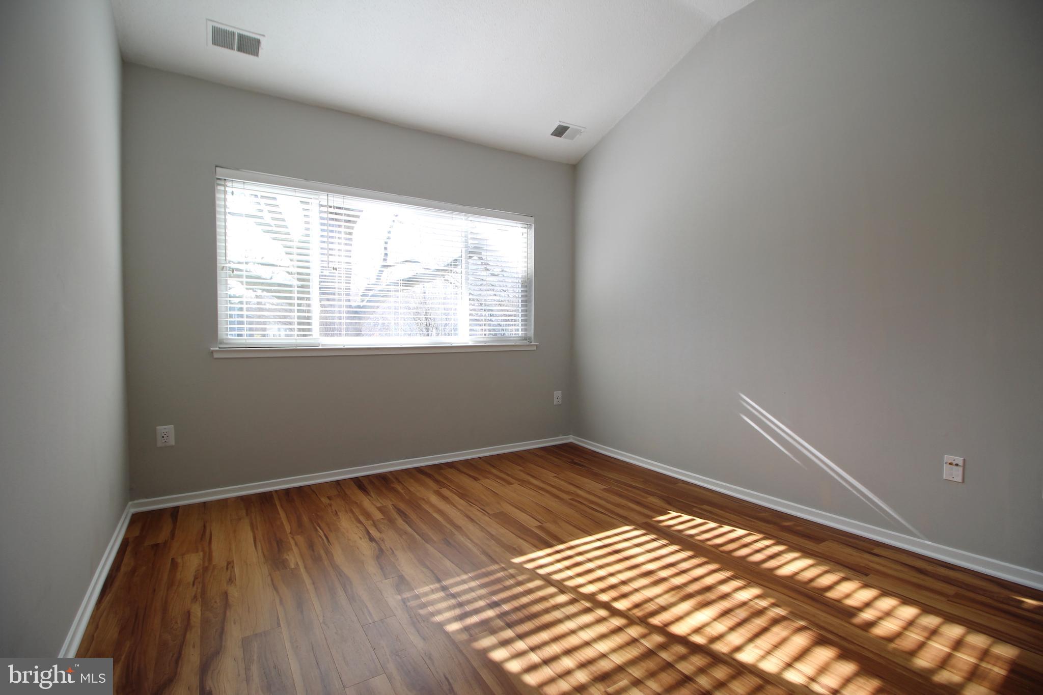1956A Villaridge Drive, Unit 1956B Reston, VA 20191 - Photo 20 of 24 an empty room with wooden floor and windows