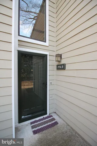 a view of a street sign under a large tree