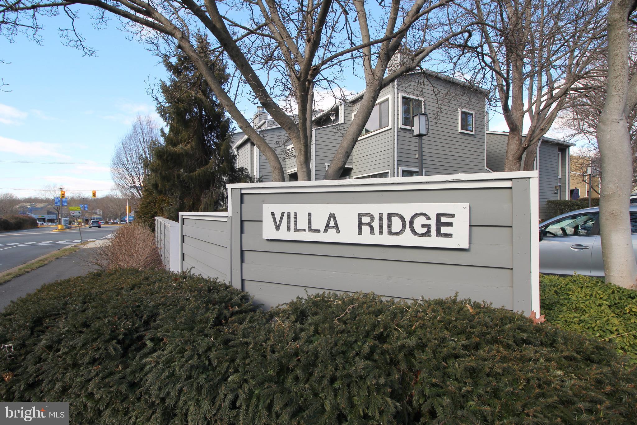 1956A Villaridge Drive, Unit 1956B Reston, VA 20191 - Photo 3 of 24 a view of a street sign under a large tree