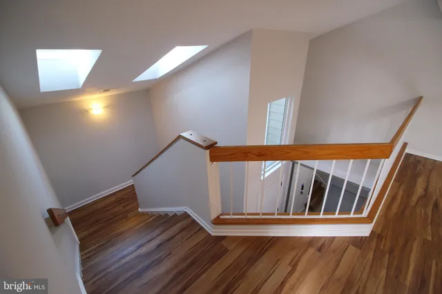 a view of a room with wooden floor and a window