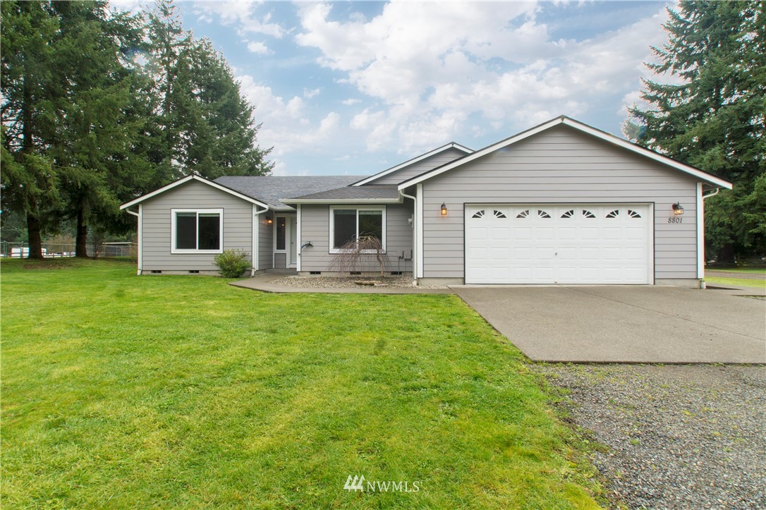 8801 178th Avenue Southwest Rochester, WA 98579 - Photo 1 of 39 a view of house with garden and tall tress