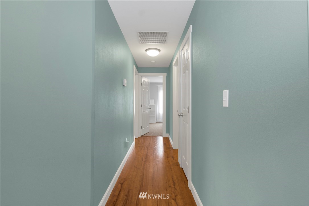 8801 178th Avenue Southwest Rochester, WA 98579 - Photo 23 of 39 a view of a hallway with wooden floor