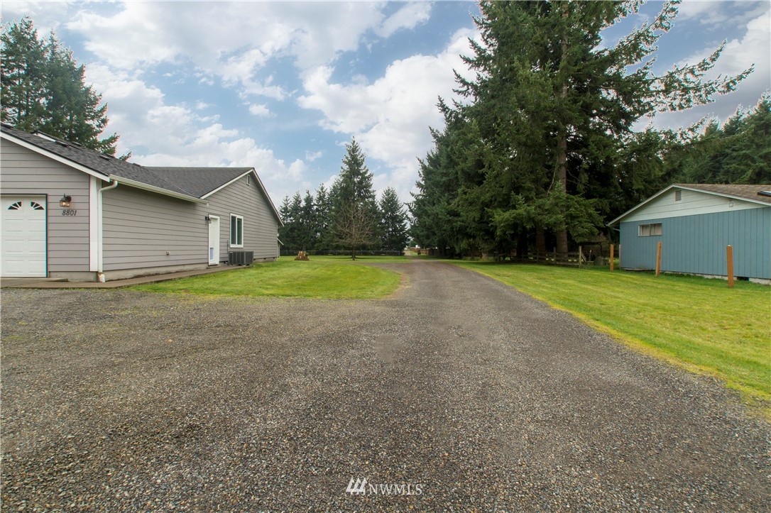 8801 178th Avenue Southwest Rochester, WA 98579 - Photo 34 of 39 a view of a house with backyard and trees