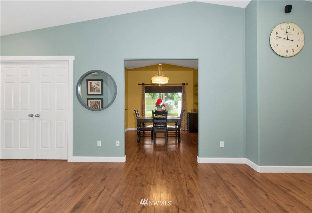 8801 178th Avenue Southwest Rochester, WA 98579 - Photo 8 of 39 an empty room with wooden floor and windows