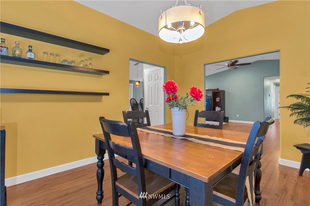 8801 178th Avenue Southwest Rochester, WA 98579 - Photo 10 of 39 a view of a dining room with furniture and wooden floor