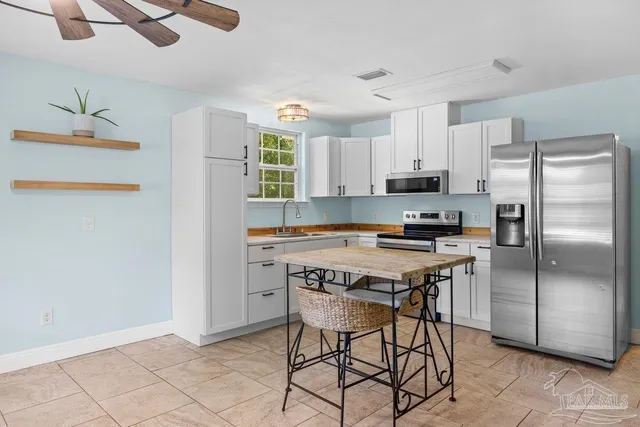 a kitchen with stainless steel appliances a stove a refrigerator and a refrigerator