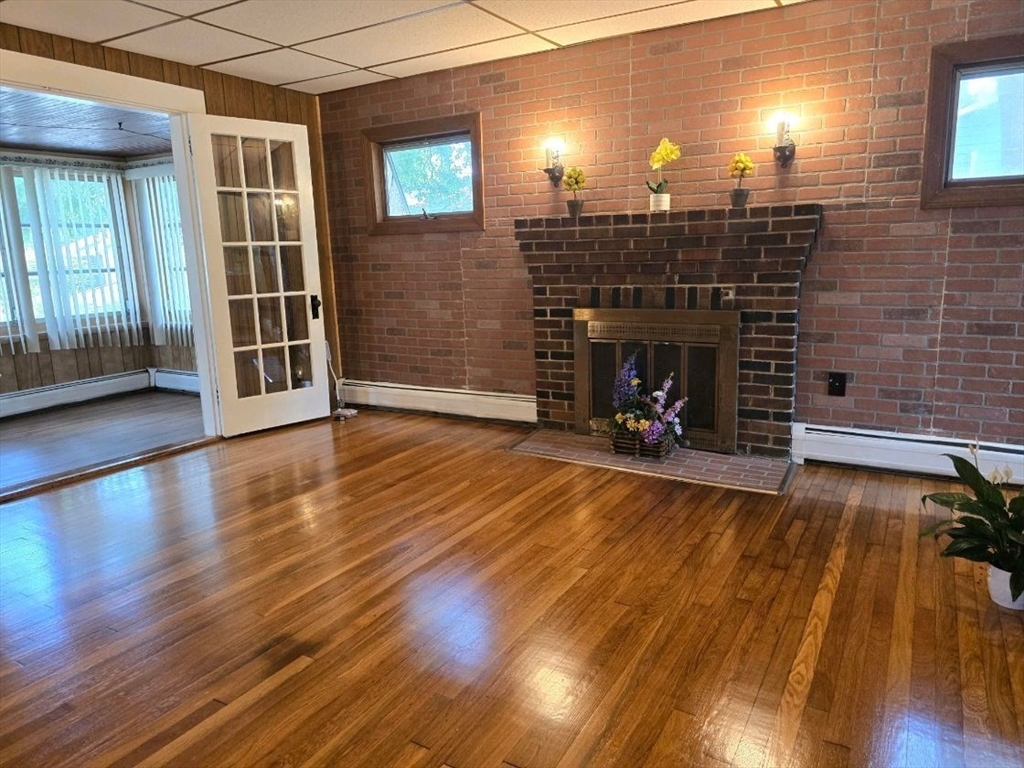 43 Shore Avenue Wareham, MA 02571 - Photo 14 of 32 a view of a livingroom with wooden floor and a fireplace