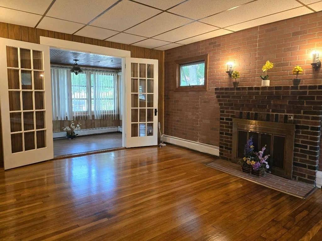 43 Shore Avenue Wareham, MA 02571 - Photo 7 of 32 a view of a livingroom with wooden floor and a fireplace