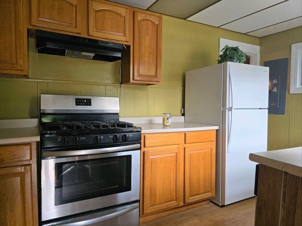 43 Shore Avenue Wareham, MA 02571 - Photo 8 of 32 a kitchen with granite countertop cabinets and refrigerator stove