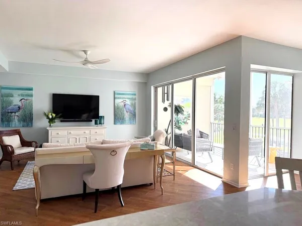 a living room with a flat screen tv and a large window