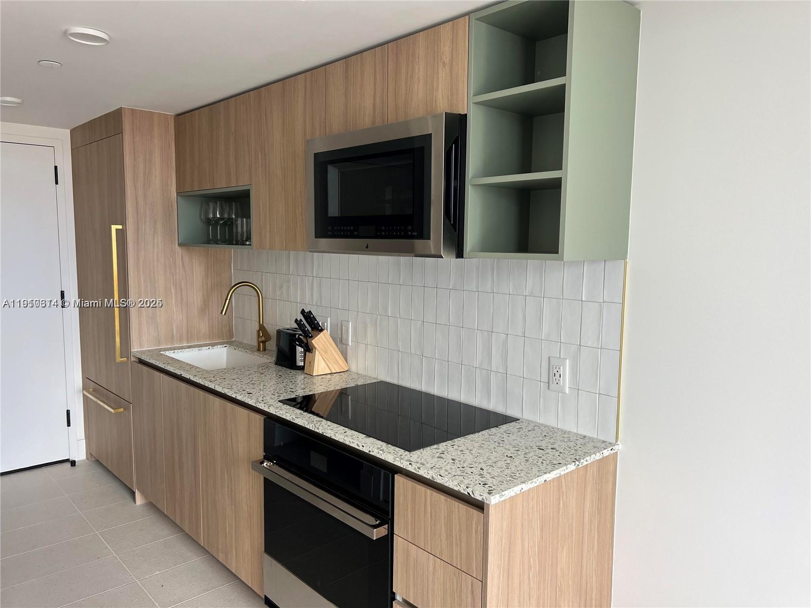 159 Northeast 6th Street, Unit 2807 Miami, FL 33132 - Photo 3 of 13 a kitchen with a sink and a microwave