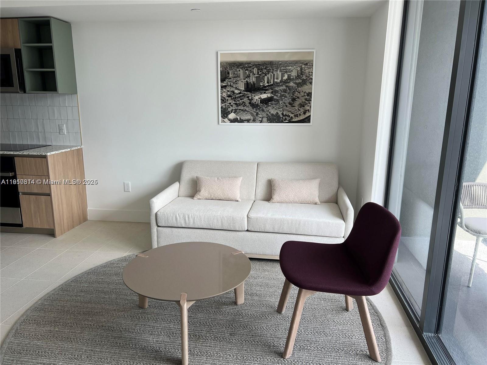 159 Northeast 6th Street, Unit 2807 Miami, FL 33132 - Photo 5 of 13 a living room with furniture and a couch