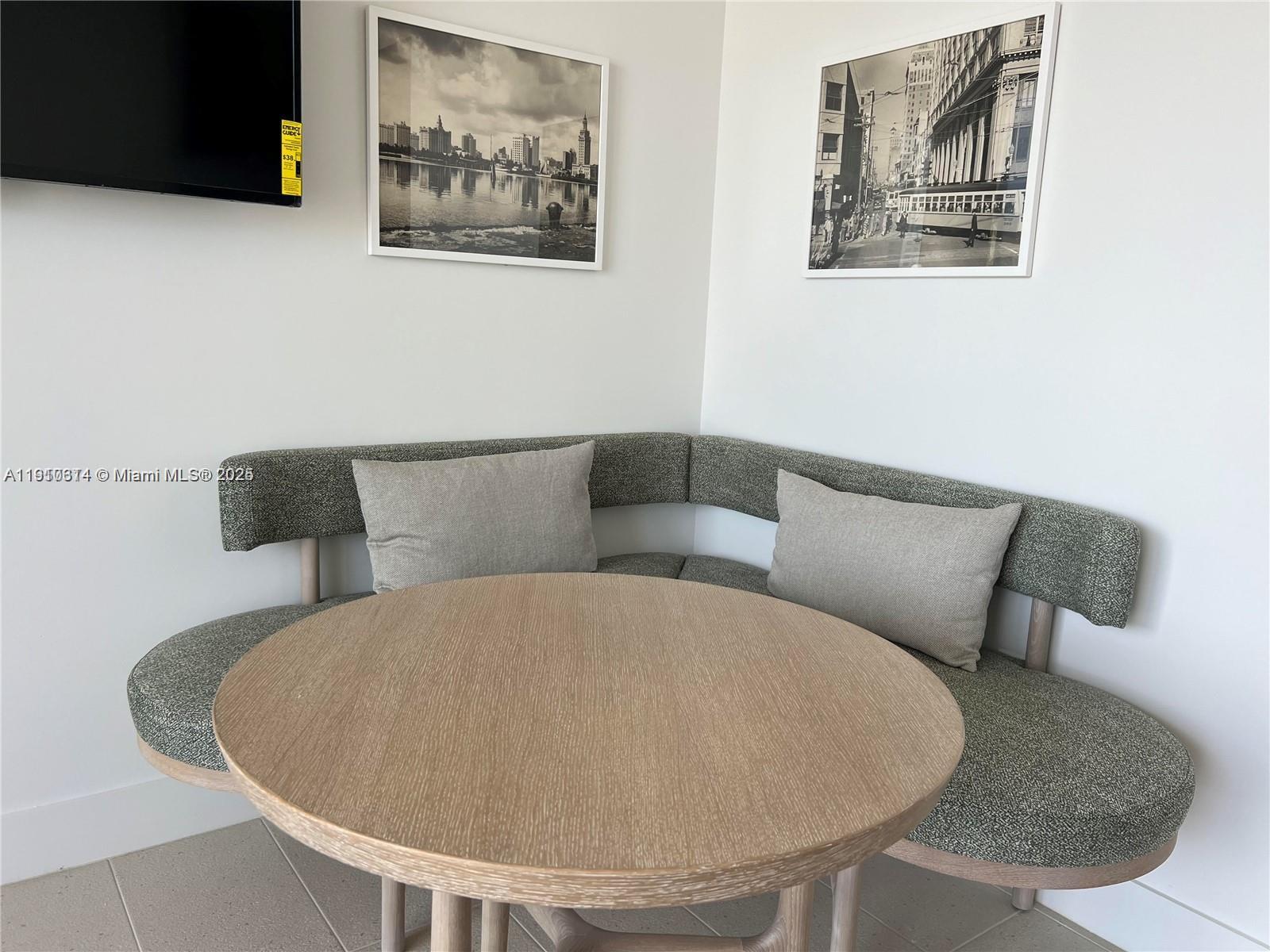 159 Northeast 6th Street, Unit 2807 Miami, FL 33132 - Photo 6 of 13 a living room with a couch and a potted plant