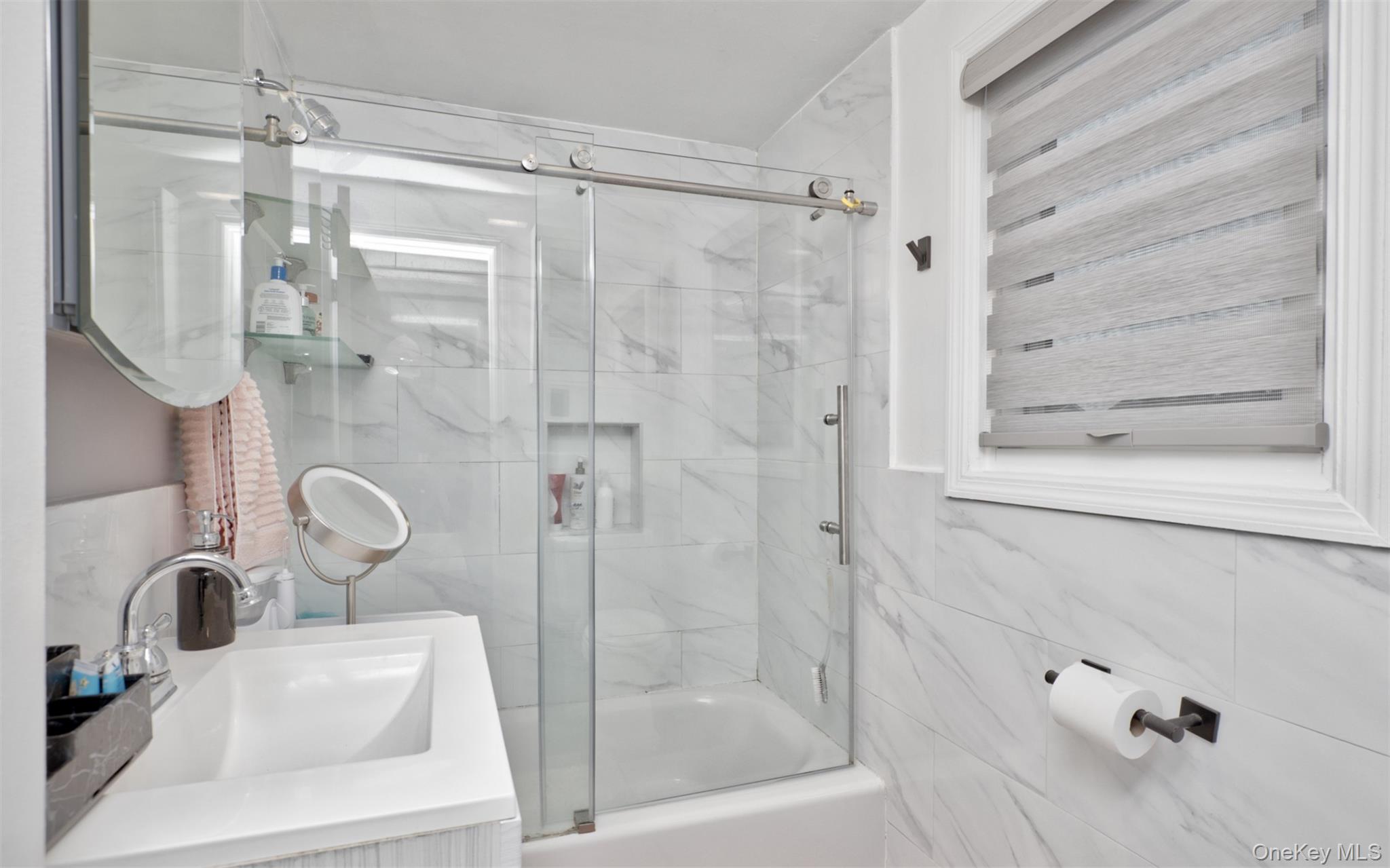 383 White Road Mineola, NY 11501 - Photo 12 of 21 a bathroom with a shower sink and mirror