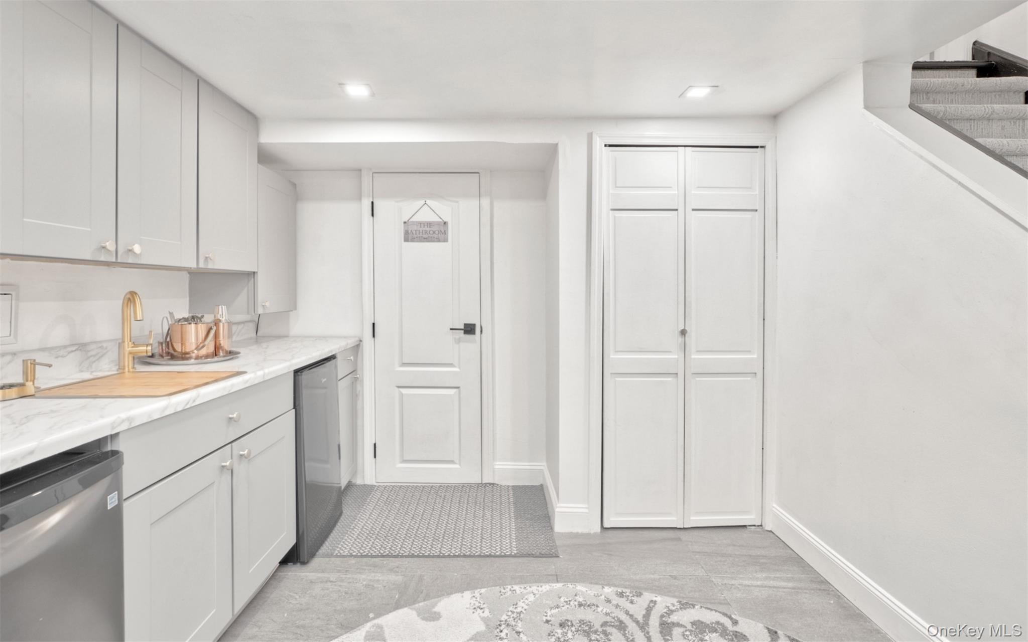 383 White Road Mineola, NY 11501 - Photo 16 of 21 a kitchen with white cabinets and sink