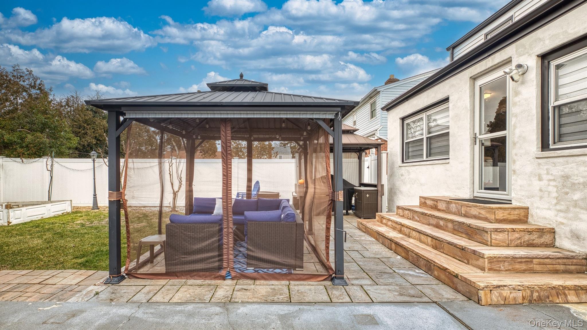 383 White Road Mineola, NY 11501 - Photo 19 of 21 a view of a porch with furniture and floor to ceiling window