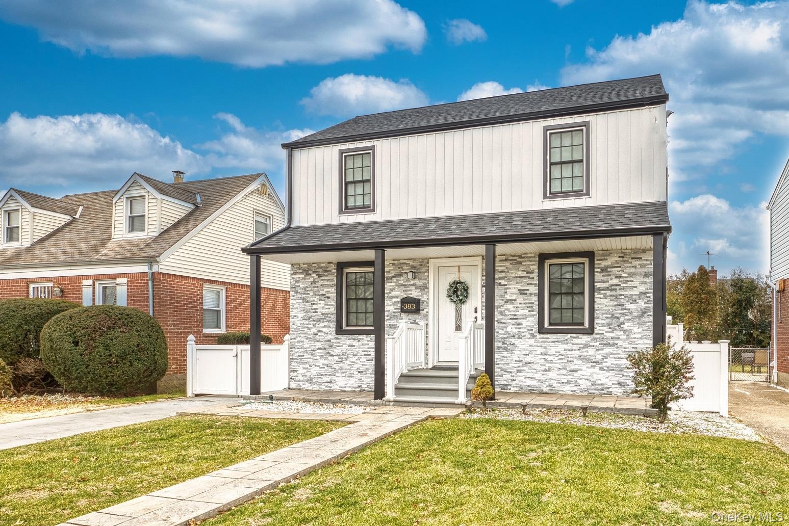 383 White Road Mineola, NY 11501 - Photo 2 of 21 a front view of a house with a yard