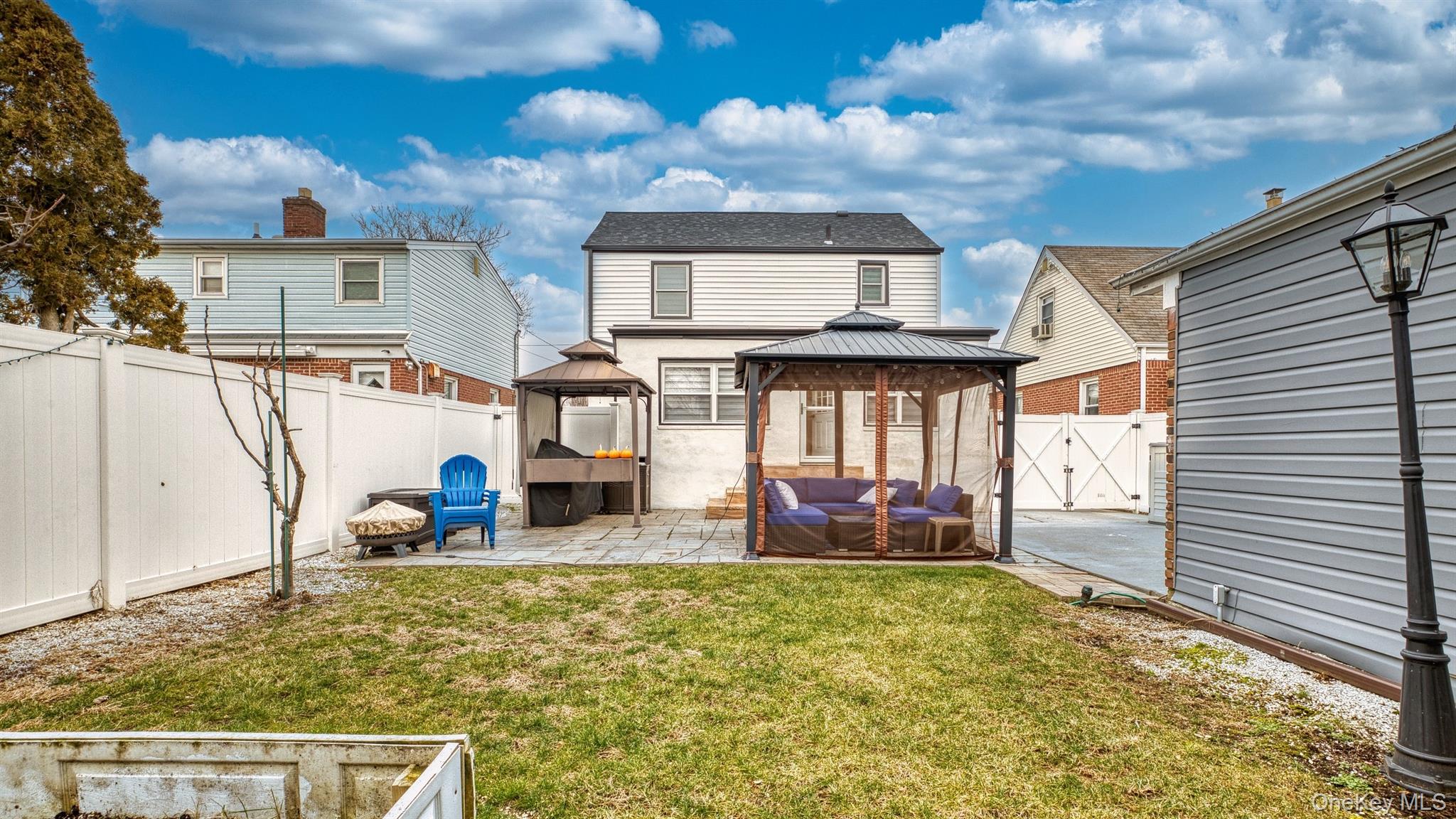 383 White Road Mineola, NY 11501 - Photo 21 of 21 a view of a house with a barbeque and wooden stairs