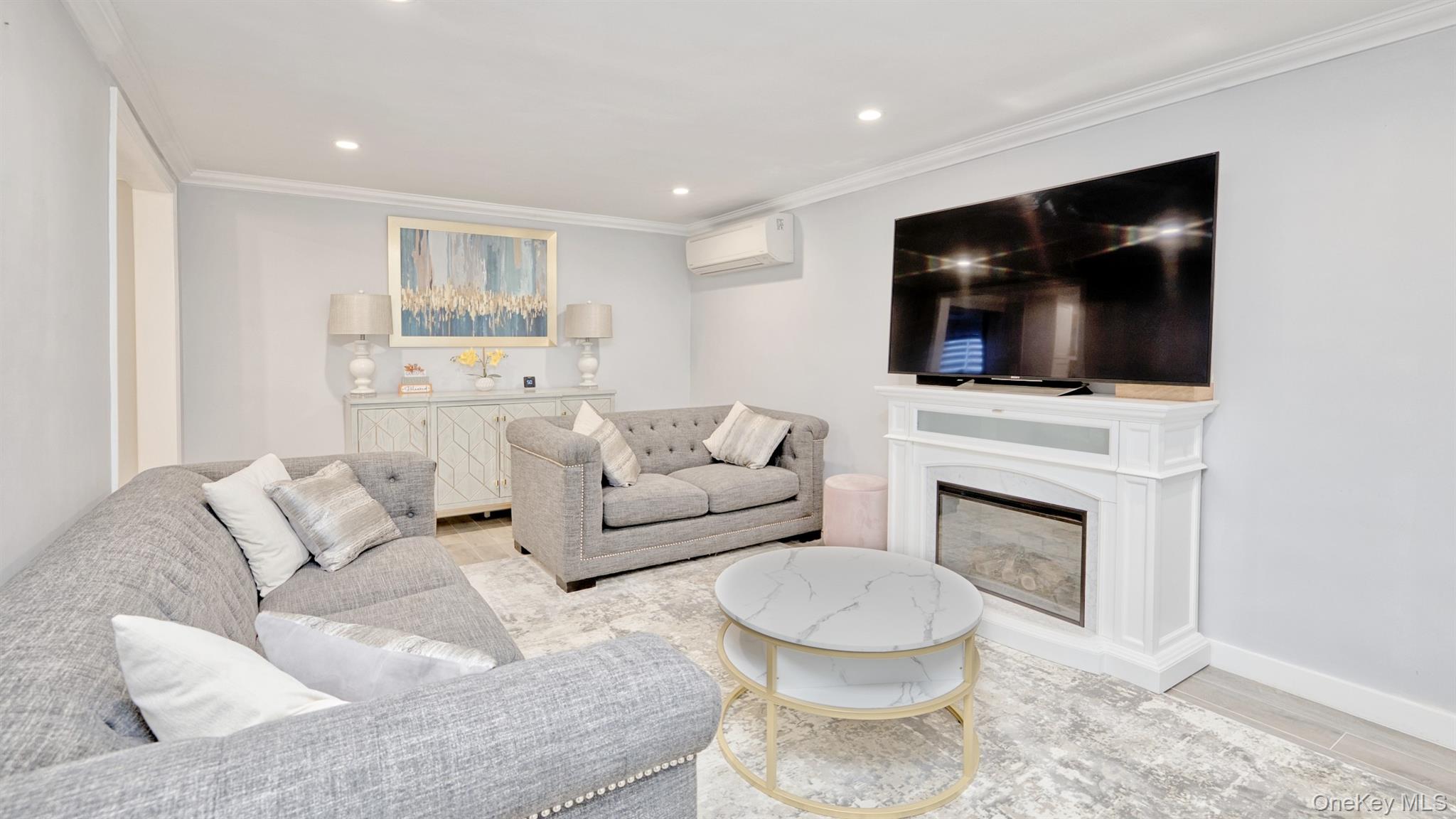 383 White Road Mineola, NY 11501 - Photo 3 of 21 a living room with furniture a flat screen tv and a fireplace