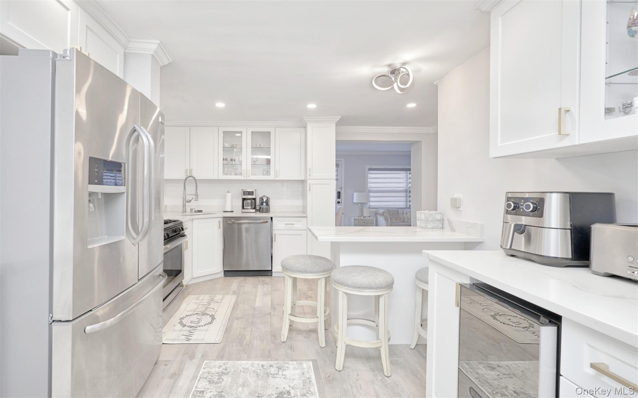 383 White Road Mineola, NY 11501 - Photo 4 of 21 a kitchen with white cabinets and refrigerator