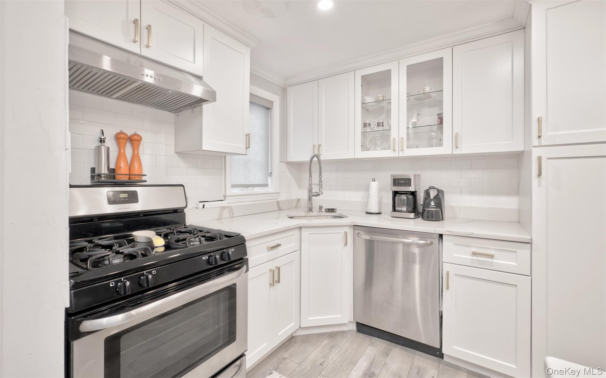 383 White Road Mineola, NY 11501 - Photo 7 of 21 a kitchen with white cabinets and appliances