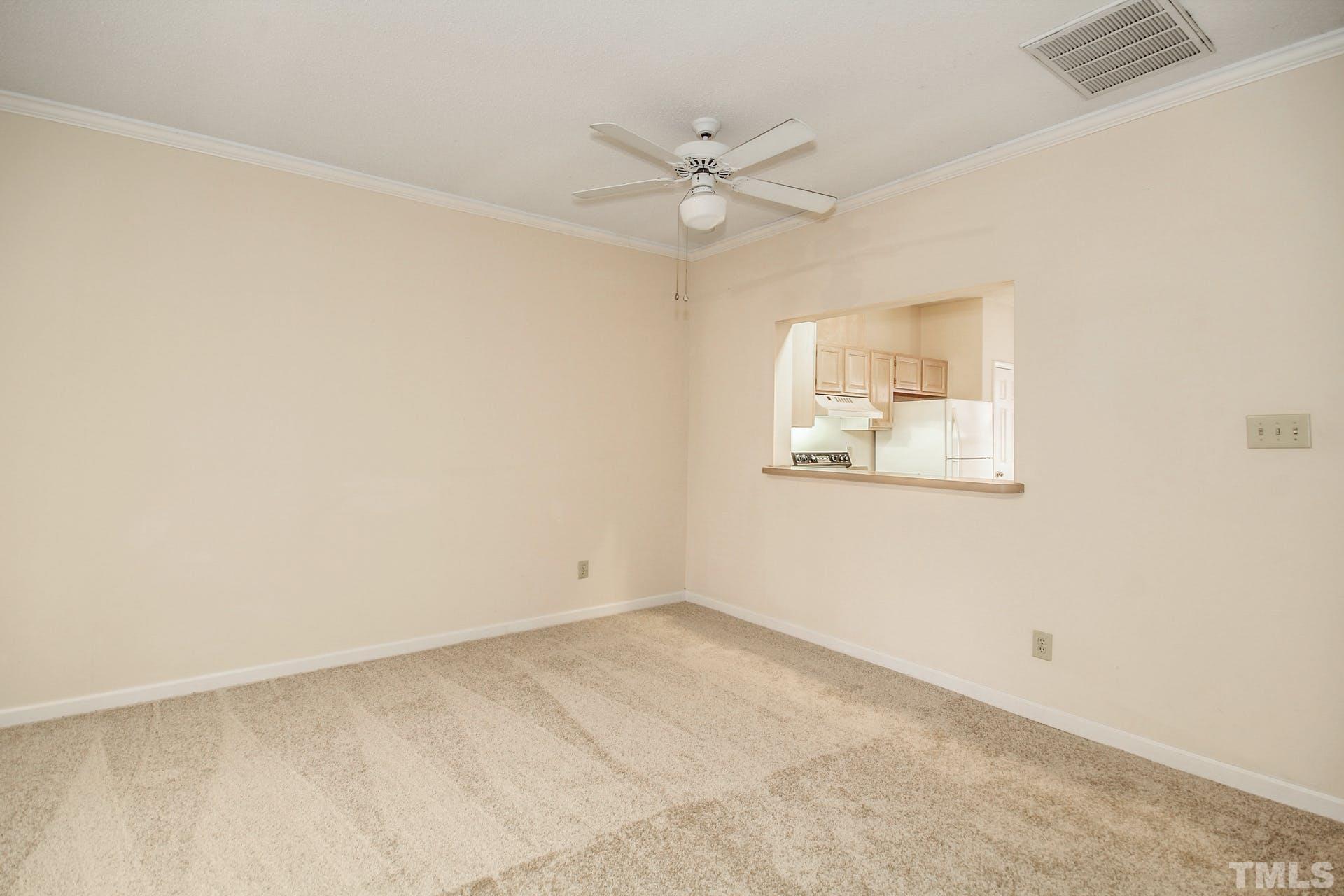 4460 Still Pines Drive Raleigh, NC 27613 - Photo 4 of 14 an empty room with a window and ceiling fan