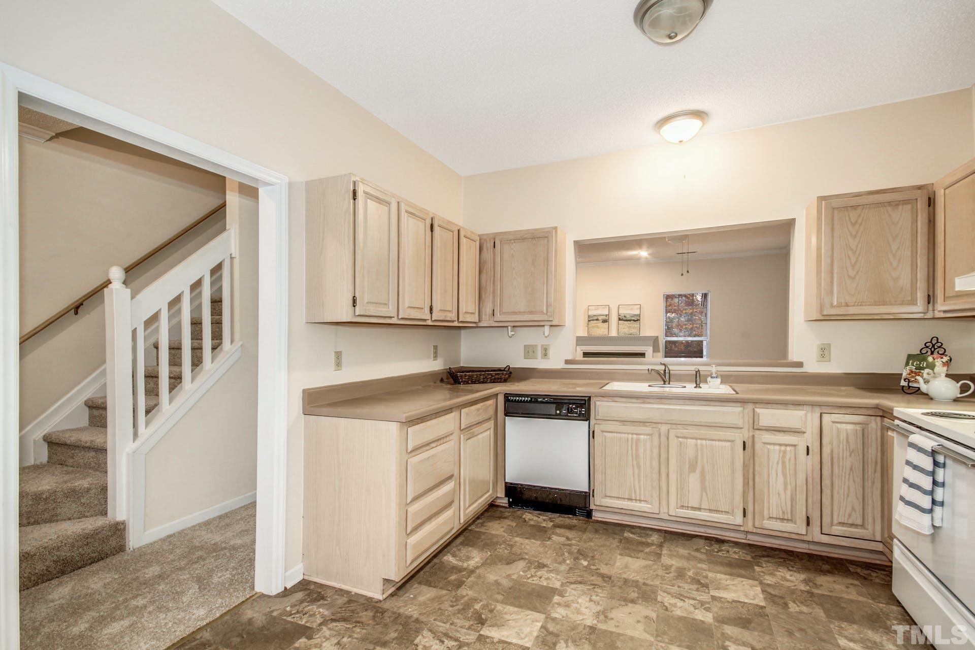 4460 Still Pines Drive Raleigh, NC 27613 - Photo 7 of 14 a kitchen with a sink and cabinets