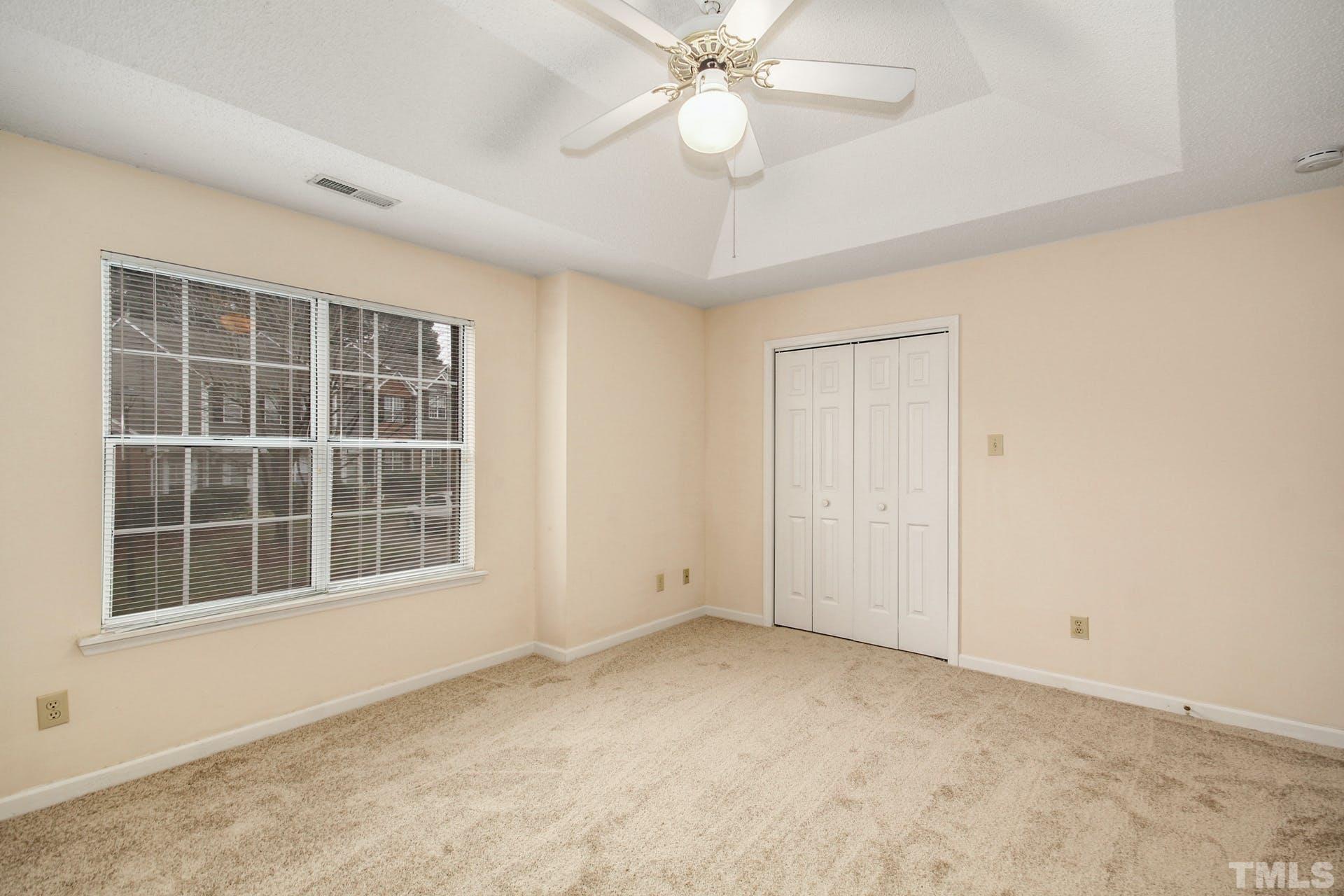 4460 Still Pines Drive Raleigh, NC 27613 - Photo 8 of 14 an empty room with windows and fan