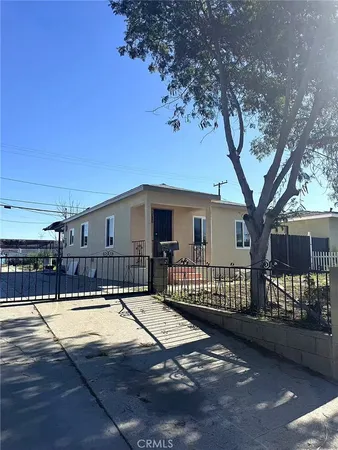 a view of a house with a swimming pool and a yard